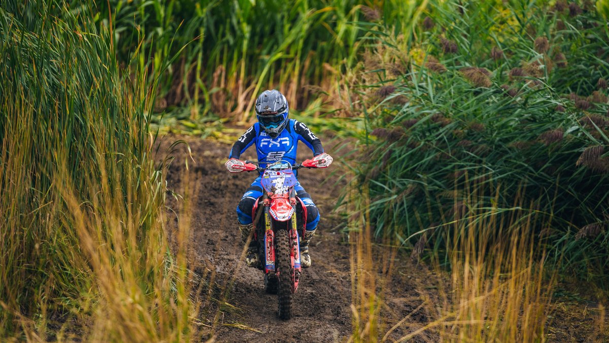 Off-road racer rides a narrow cornfield lane at the Dynamite Grand Prix, Cache Valley MX Park, Preston, Idaho