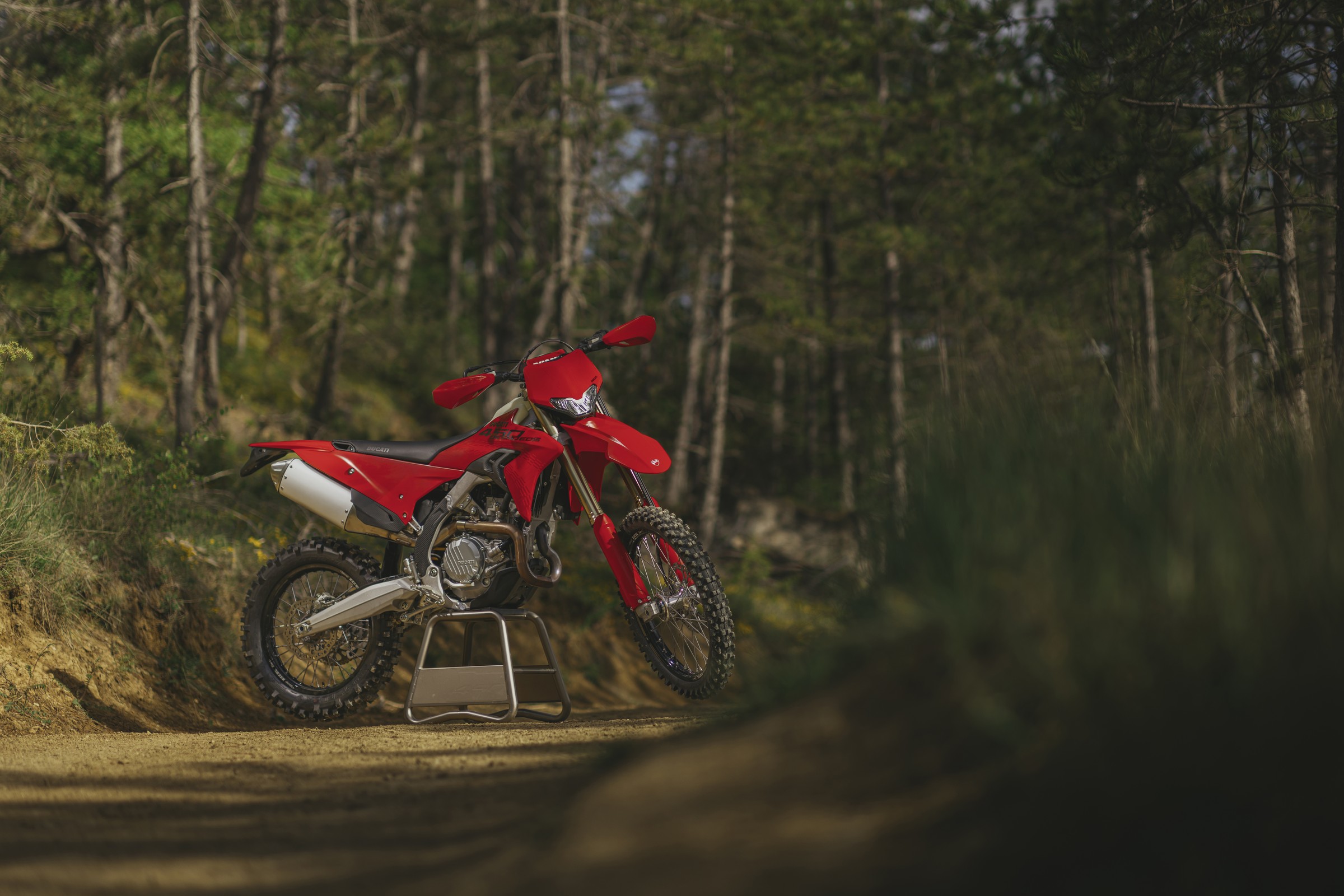 Ducati Desmo450 EDS on paddock stand in woods