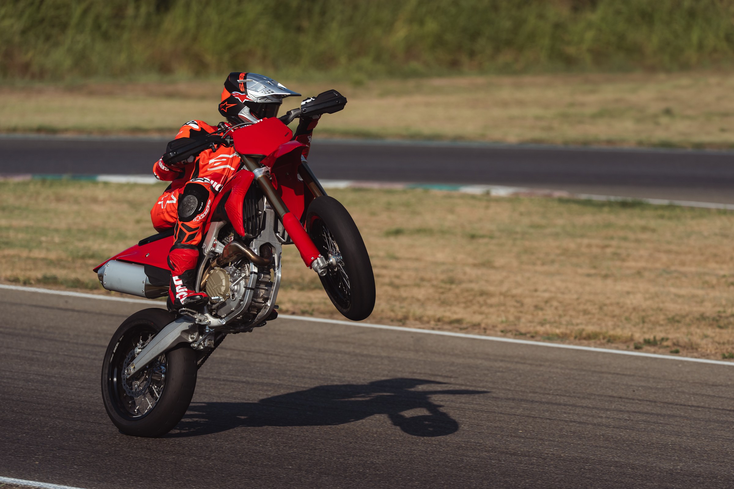 Desmo450 SM wheelie on asphalt with slick tires