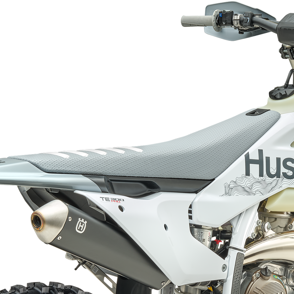 Husqvarna TE 300 Pro seat detail, grey ribbed seat cover, white side panel with TE 300 Pro decal and black silencer