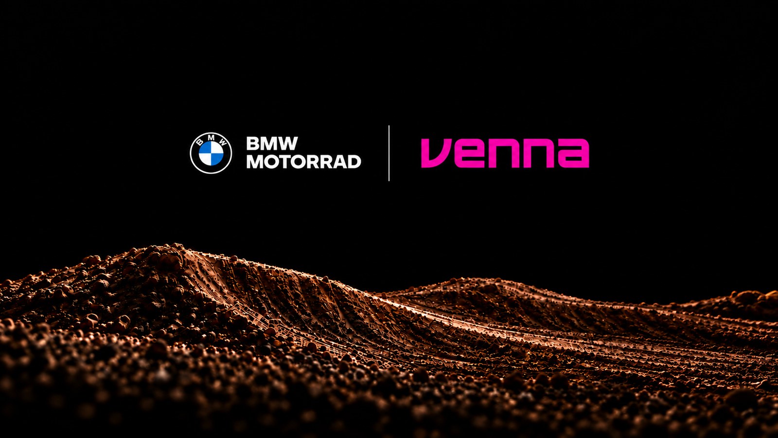 White BMW Motorrad logo and pink Venna wordmark side by side, separated by a thin vertical line, on a black background above a rippled field of brown dirt
