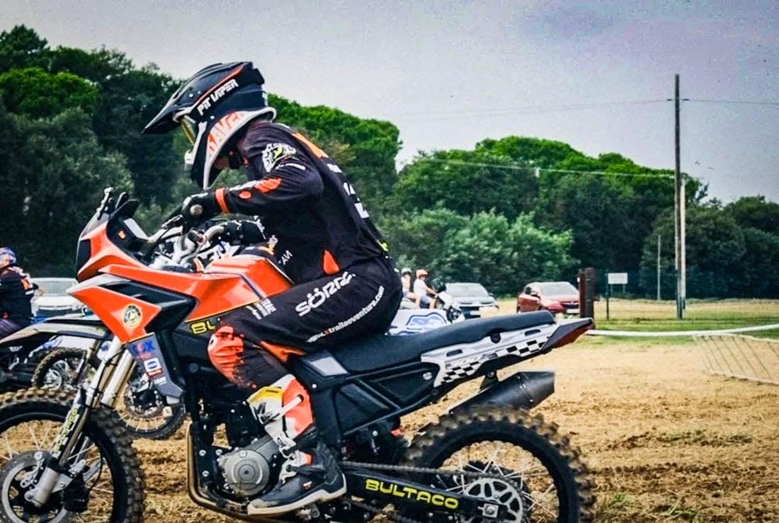 Rider aboard orange Bultaco Rally GT 300 with knobby tires outdoors