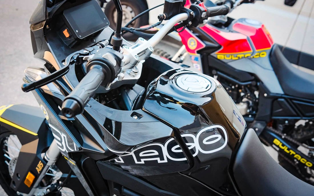 High-angle view of black Bultaco Rally GT 300 tank/fairing and TFT dash with second bike behind