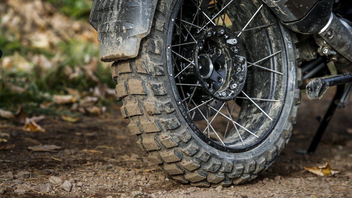 Michelin Anakee Wild 50/50 dual-purpose tire on an adventure bike's spoked wheel on a dirt trail