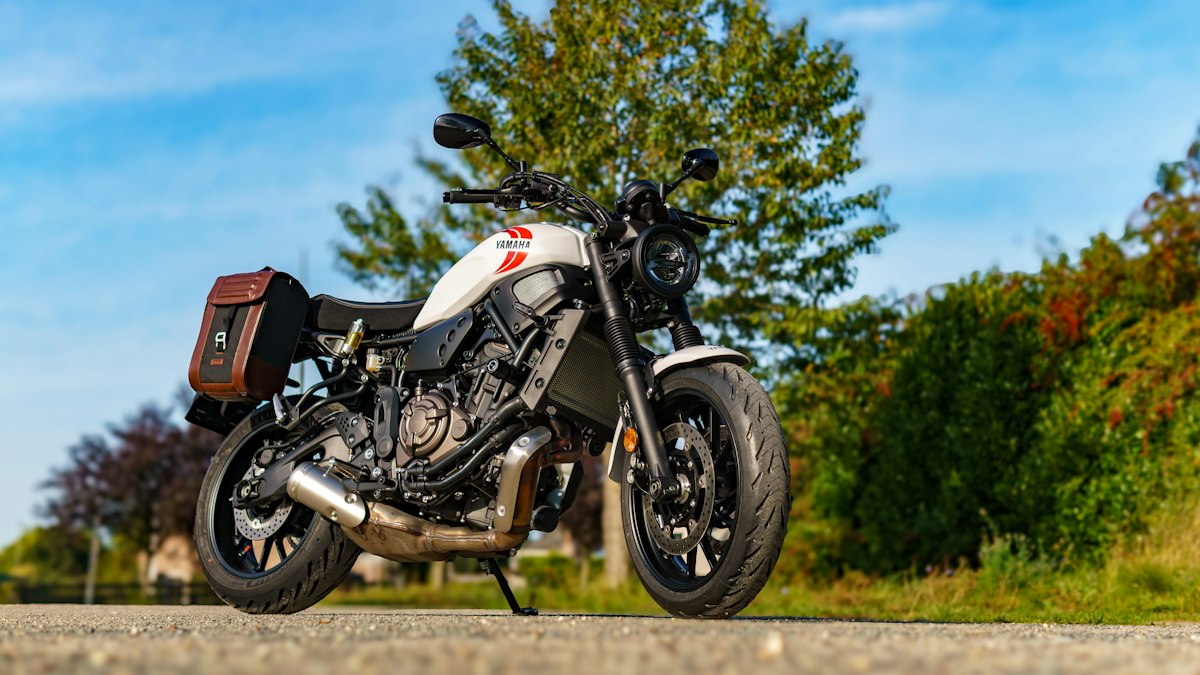 Motorcycle with soft saddlebags on a roadside — topic object for day-ride packing