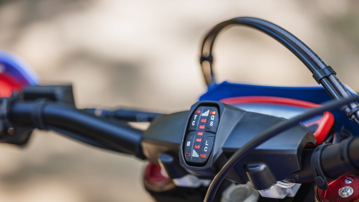 Close-up of a dirt-bike digital dash and handlebar switchgear